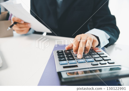 Woman calculating monthly home expenses, taxes, bank account balance and credit card bills payment, Income is not enough for expenses. financial planning, business calculate tax, investment finance. 130122991