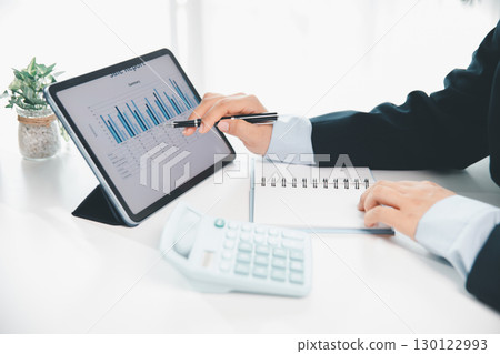 Businesswoman analysis with financial data, marketing business strategy project, Business financing accounting banking concept, finances, calculate about cost to real estate investment, tax system. Businesswoman analysis with financial data, marketing business strategy project, Business financing accounting banking concept, finances, calculate about cost to real estate investment, tax system. 130122993