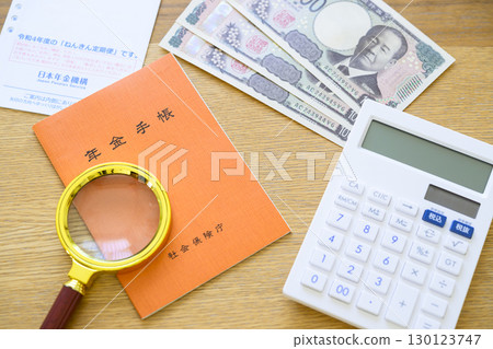 Pension book and pension newsletter (plus magnifying glass) 130123747