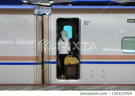 Passengers boarding the Hokuriku Shinkansen, tourists at Tokyo Station, Shinkansen platform 130123954