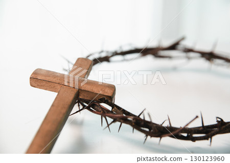 Cross and crown of thorns, often seen in gold crucifix symbols, represent the sacrifice of Jesus Christ-central to Easter message and the foundation of faith in the Christian religion. Cross and crown of thorns, often seen in gold crucifix symbols, represent the sacrifice of Jesus Christ-central to Easter message and the foundation of faith in the Christian religion. 130123960