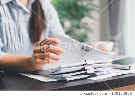 Business woman analyze calculate company financial, tax results office accounting statistics analytical research. calculating business balance prepare tax reduction. Tax deduction planning concept. Business woman analyze calculate company financial, tax results office accounting statistics analytical research. calculating business balance prepare tax reduction. Tax deduction planning concept. 130123999