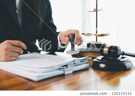 Justice and lawfirm concept. Female lawyer in office with brass scale. Woman hand gavel to bang. Law and justice trial session. Business lawyer notary stamping agreement, company secretary, validity. 130124152