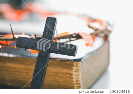 Crown of thorns and cross powerful symbols in Christianity, representing holy sacrifice of Jesus Christ in Bible and serving as enduring reminders of faith and core of Christian religion. 130124418