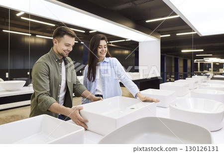 Happy Couple Choosing A Bathroom Sink In Plumbing Store 130126131