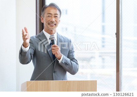 Senior businessman giving a presentation 130126621