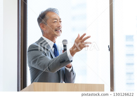 Senior businessman giving a presentation 130126622