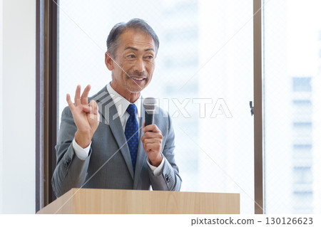 Senior businessman giving a presentation 130126623