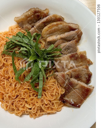 Spicy bibimmyeon with chewy noodles paired with juicy grilled samgyeopsal, offering a perfect harmony of heat, savoriness, and satisfying textures in every bold and delicious bite. Spicy bibimmyeon with chewy noodles paired with juicy grilled samgyeopsal, offering a perfect harmony of heat, savoriness, and satisfying textures in every bold and delicious bite. 130127506
