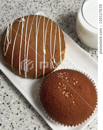 Soft coffee buns with a crispy coffee-flavored topping and a buttery filling. These aromatic treats offer a perfect blend of sweetness and coffee essence, ideal for pairing with your favorite brew. Soft coffee buns with a crispy coffee-flavored topping and a buttery filling. These aromatic treats offer a perfect blend of sweetness and coffee essence, ideal for pairing with your favorite brew. 130127639