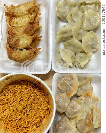 A comforting bowl of spicy ramyun paired with tender, flavorful mandu dumplings. This satisfying combination offers chewy noodles, rich broth, and savory dumpling goodness. 130127648