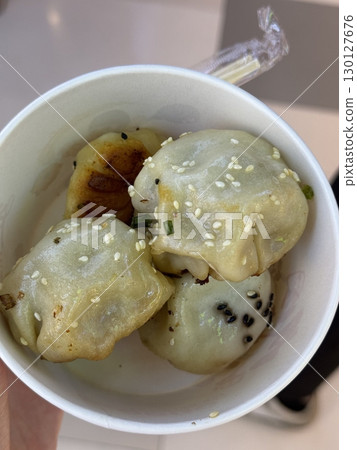 Steamed or fried Korean mandu dumplings filled with a savory mix of meat and vegetables. Crispy on the outside, tender on the inside perfect for dipping in soy sauce or chili oil! 130127676