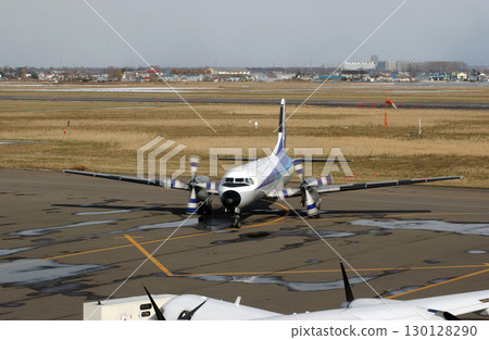 A propeller plane arriving at an airport in autumn 130128290