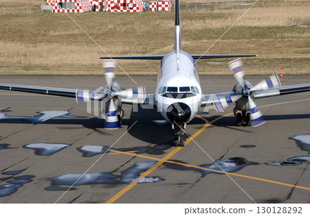Front view of a propeller plane arriving at an airport in autumn 130128292