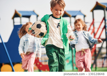 Cheerful kids are having fun on the playground Cheerful kids are having fun on the playground 130128648
