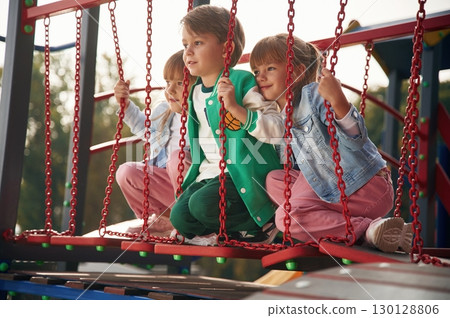 Two girl and one boy. Kids are having fun on the playground Two girl and one boy. Kids are having fun on the playground 130128806