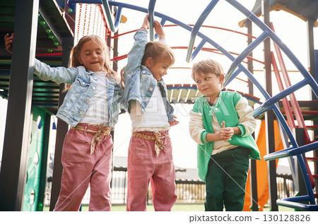 Front view. Kids are having fun on the playground 130128826