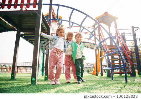 Front view. Kids are having fun on the playground 130128828