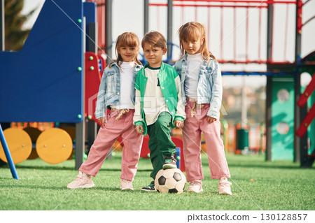 One boy and two girls. Kids are having fun on the playground 130128857