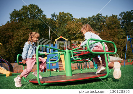 Autumn season. Kids are having fun on the playground Autumn season. Kids are having fun on the playground 130128895
