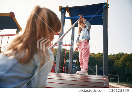 In casual clothes. Kids are having fun on the playground In casual clothes. Kids are having fun on the playground 130128899