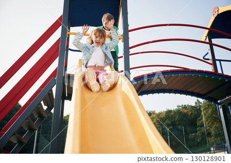 Beautiful sunlight. Kids are having fun on the playground Beautiful sunlight. Kids are having fun on the playground 130128901