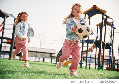 Front view. Kids are having fun on the playground 130128902