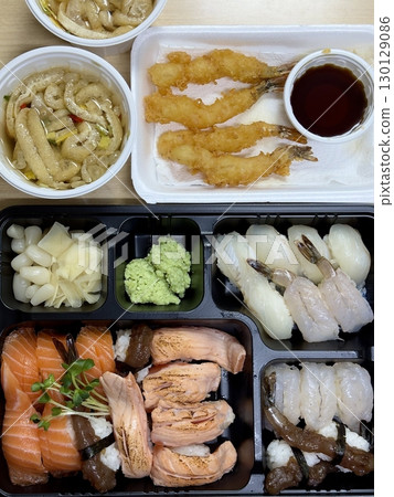 Fresh assorted sushi paired with crispy, golden ebi furai, offering a perfect blend of delicate flavors and crunchy textures in every satisfying and visually appealing bite. 130129086