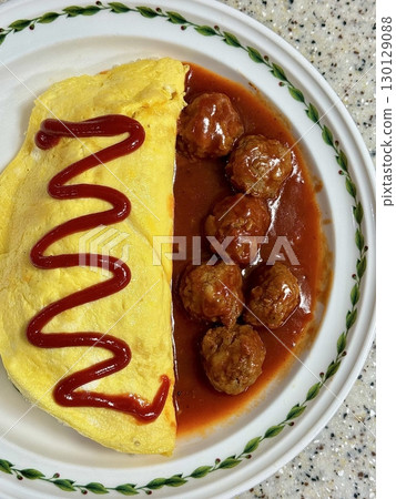 Fluffy omurice filled with savory fried rice topped with a soft omelet, paired with juicy, flavorful meatballs. A perfect combination of comfort and heartiness in every satisfying bite. 130129088