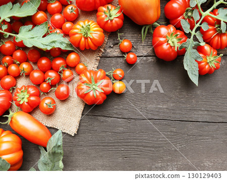 The harvest of assorted tomatoes. Variety fresh colorful tomatoes. Tomatoes different varieties	 130129403