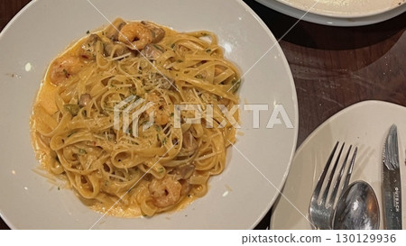 Creamy spaghetti carbonara made with rich egg yolk sauce, crispy bacon, parmesan cheese, and freshly ground black pepper for a classic, indulgent Italian pasta dish. 130129936