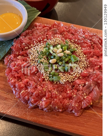 Fresh yukhoe with finely sliced raw beef, seasoned with soy sauce, sesame oil, and spices, topped with a rich egg yolk. A flavorful and delicate Korean delicacy, perfect for meat lovers! Fresh yukhoe with finely sliced raw beef, seasoned with soy sauce, sesame oil, and spices, topped with a rich egg yolk. A flavorful and delicate Korean delicacy, perfect for meat lovers! 130129949