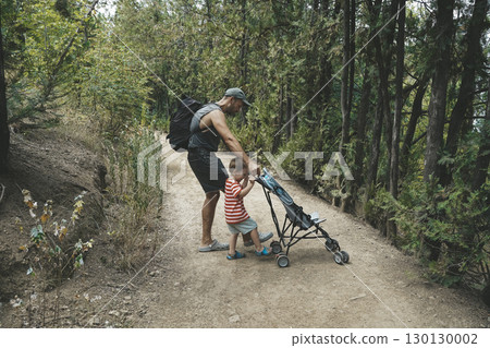Father and Toddler Spending Time in Summer Forest Father and Toddler Spending Time in Summer Forest 130130002