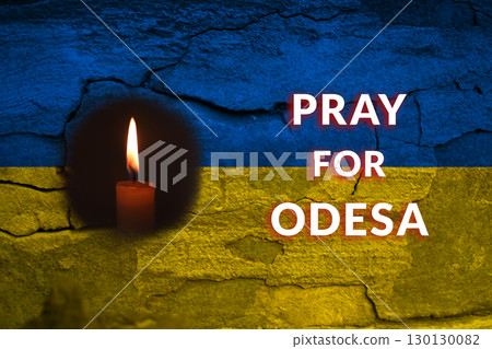 A powerful and somber image of a Ukrainian flag and a candle in Odesa, in a gesture of mourning after the shelling by Russia. Ukrainian flag mourning tribute. Odesa shelling memorial candle 130130082