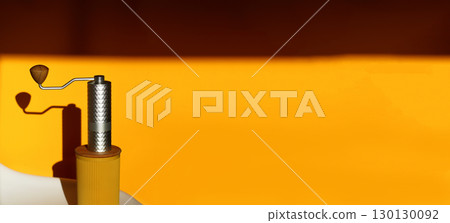 A captivating banner with a professional grinder and coffee on a clean yellow background. coffee grinder yellow background copy space. minimalist coffee product shot A captivating banner with a professional grinder and coffee on a clean yellow background. coffee grinder yellow background copy space. minimalist coffee product shot 130130092