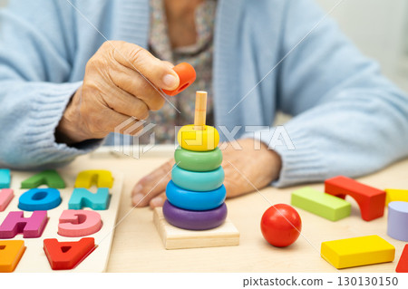 Alzheimer disease AD, Asian elderly woman patient suffering from dementia learn practical motor skills rehabilitation. Alzheimer disease AD, Asian elderly woman patient suffering from dementia learn practical motor skills rehabilitation. 130130150