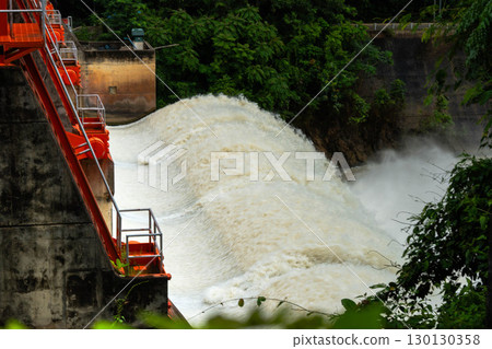 Water rushing out from dam gate with strong current and foam. 130130358