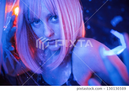 Focused close up view. Stylish woman with white hair is behind wet transparent plastic sheet Focused close up view. Stylish woman with white hair is behind wet transparent plastic sheet 130130389