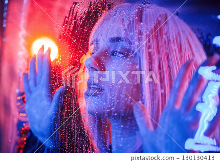 Focused close up view. Stylish woman with white hair is behind wet transparent plastic sheet 130130413
