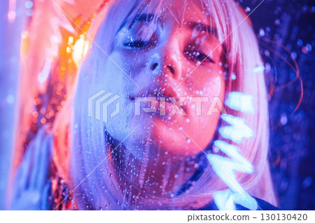 Focused close up view. Stylish woman with white hair is behind wet transparent plastic sheet 130130420
