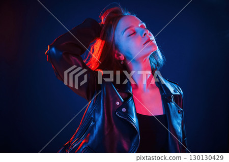 Cool young woman portrait in neon colors Cool young woman portrait in neon colors 130130429