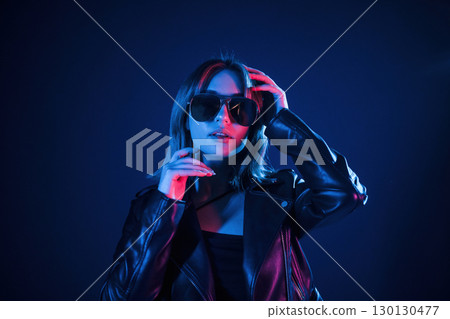 Cool young woman portrait in neon colors Cool young woman portrait in neon colors 130130477