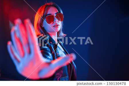 Cool young woman portrait in neon colors 130130478