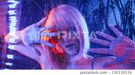 Trapped inside, with hands on surface. Stylish woman with white hair is behind wet transparent plastic sheet 130130516