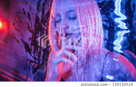 Silence gesture, be quiet, by finger. Stylish woman with white hair is behind wet transparent plastic sheet 130130529