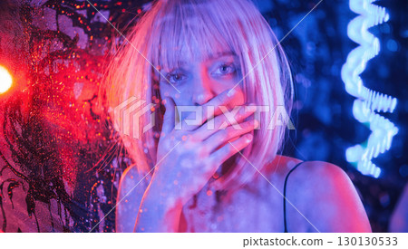 Shocked, scare look. Stylish woman with white hair is behind wet transparent plastic sheet Shocked, scare look. Stylish woman with white hair is behind wet transparent plastic sheet 130130533