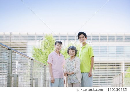 Senior women in wheelchairs and young care staff Senior women in wheelchairs and young care staff 130130585