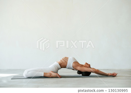 Fitness woman is indoors in white clothes Fitness woman is indoors in white clothes 130130995