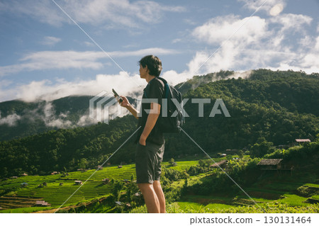 ecology travel with man solo travel and camping outdoor relax in rice field at chiangmai thailand in raining season ecology travel with man solo travel and camping outdoor relax in rice field at chiangmai thailand in raining season 130131464