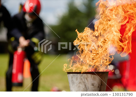 Fire Drill Training. Firefighters practice controlling an outdoor fire with extinguishers Fire Drill Training. Firefighters practice controlling an outdoor fire with extinguishers 130131790